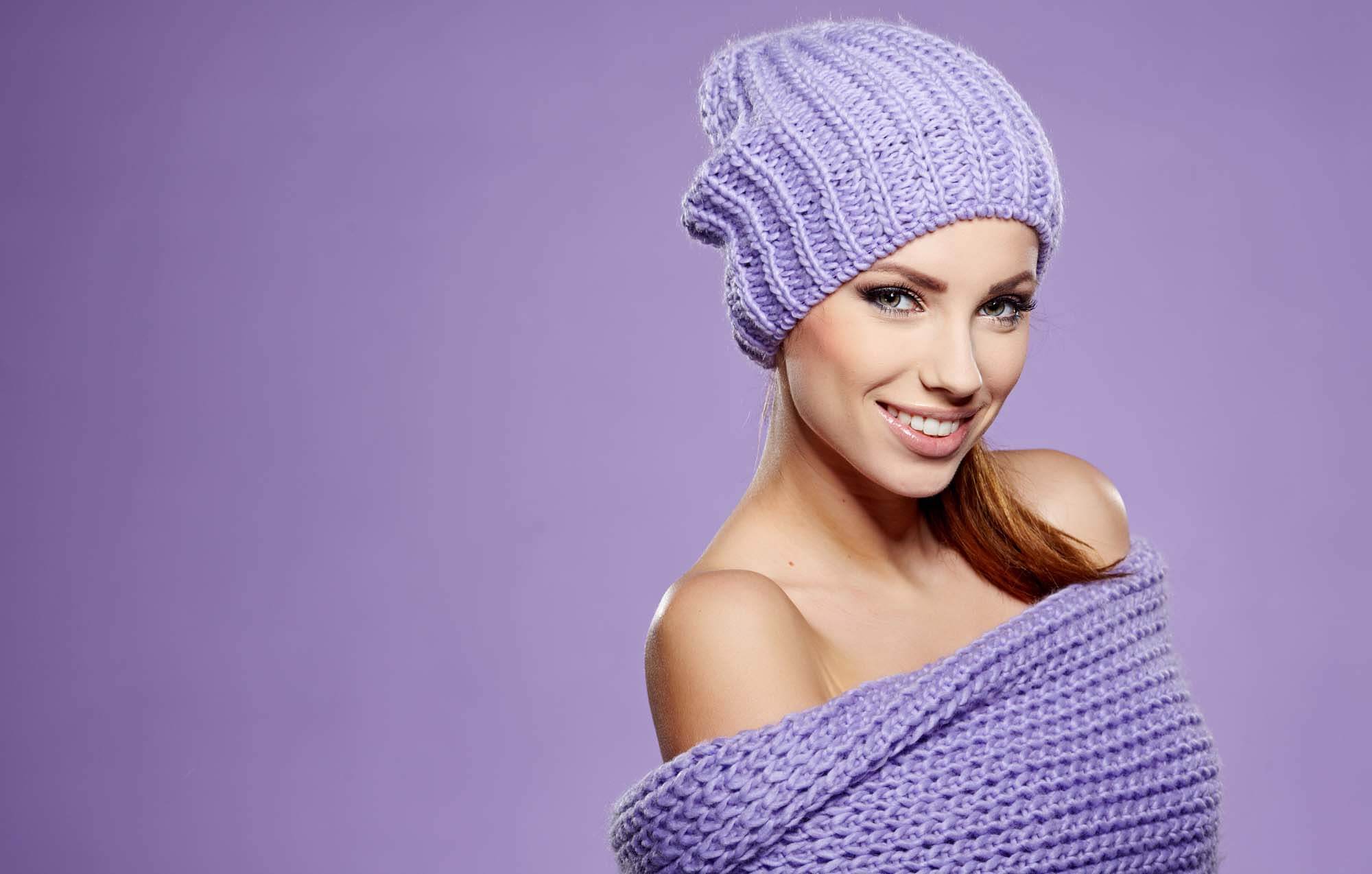 Woman in a knit beanie and purple sweater